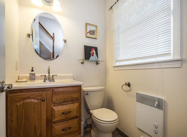 2400 Upper Cold River Rd, Shrewsbury, VT 05738 - bathroom with heating unit, toilet, vanity, and radiator heating unit