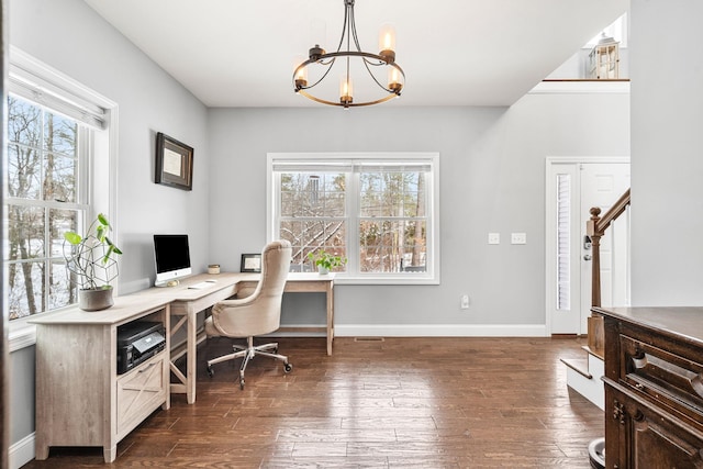 office area with an inviting chandelier, dark hardwood / wood-style floors, and plenty of natural light