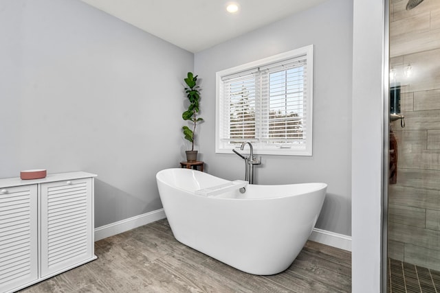 bathroom featuring hardwood / wood-style floors and shower with separate bathtub