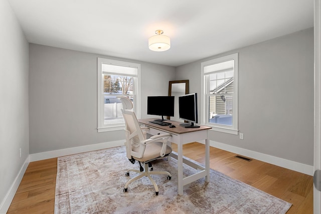 office with light hardwood / wood-style floors