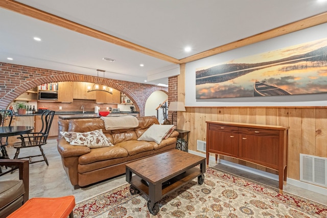 living room with wooden walls and brick wall