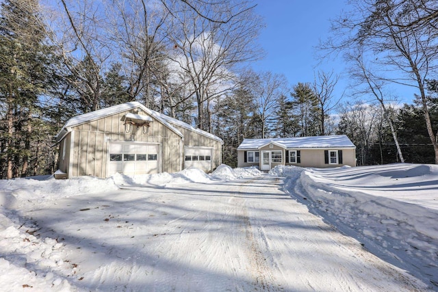 view of front of home featuring a garage and an outbuilding