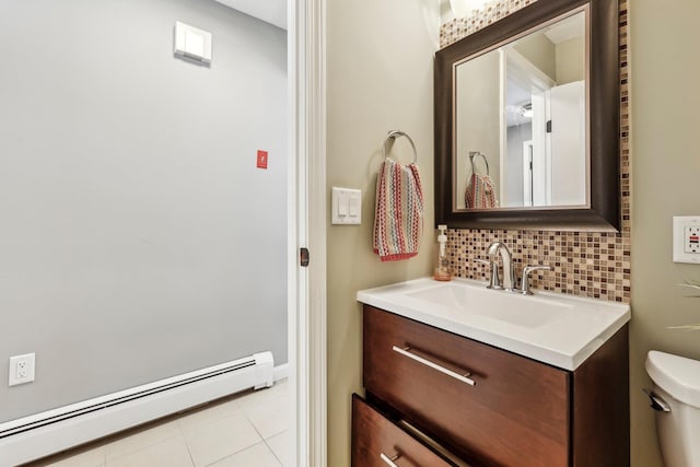 bathroom with tasteful backsplash, toilet, a baseboard radiator, tile patterned floors, and vanity