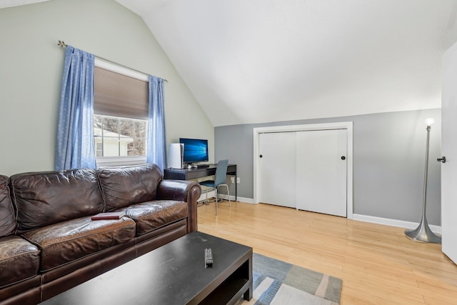 living room with lofted ceiling and hardwood / wood-style flooring