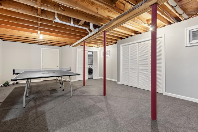 recreation room featuring independent washer and dryer and dark colored carpet