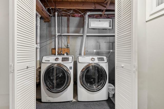 clothes washing area featuring washer and clothes dryer