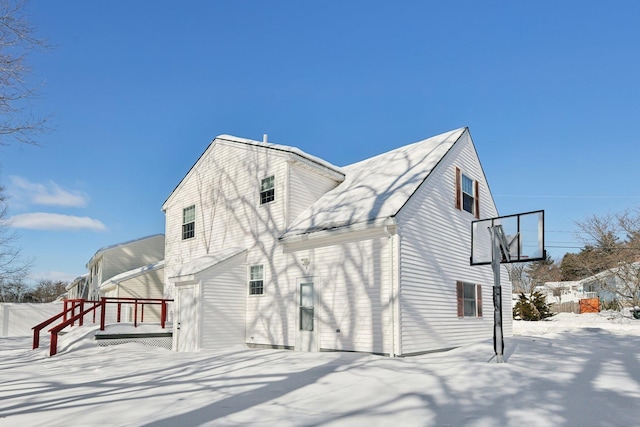 view of snow covered back of property