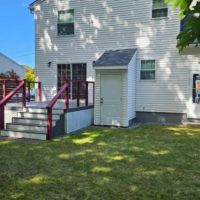 rear view of house featuring a yard and a wooden deck