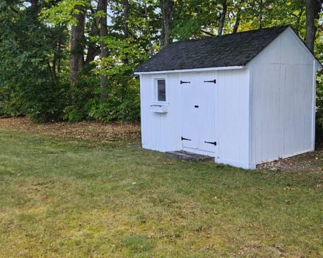 view of outdoor structure featuring a lawn