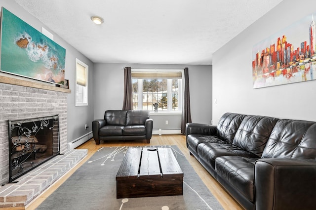 living room featuring a brick fireplace, a baseboard heating unit, and hardwood / wood-style floors