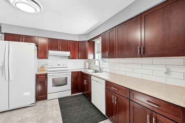 kitchen with sink, white appliances, and decorative backsplash