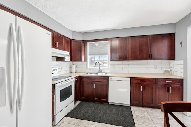 kitchen with sink, white appliances, a textured ceiling, light tile patterned flooring, and decorative backsplash