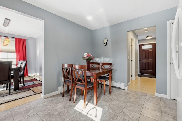 tiled dining area featuring a baseboard radiator