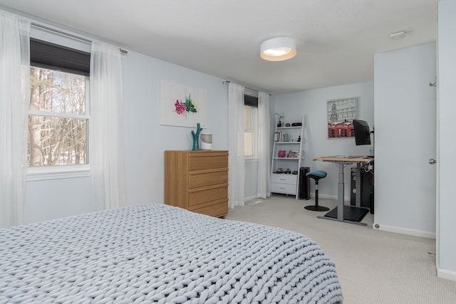 bedroom with light carpet and baseboards