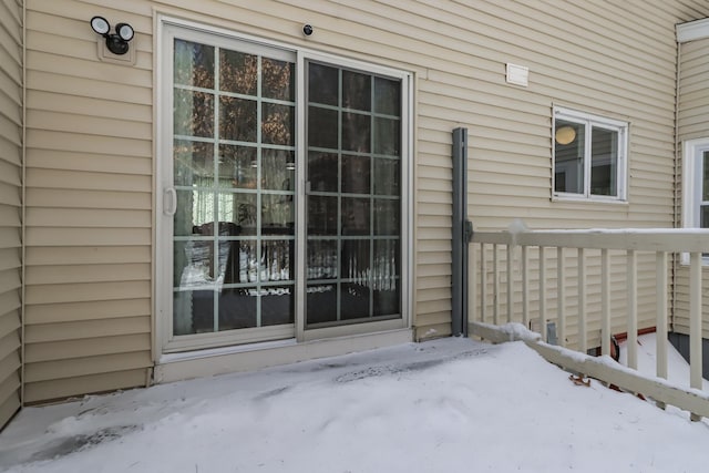 view of snow covered property entrance