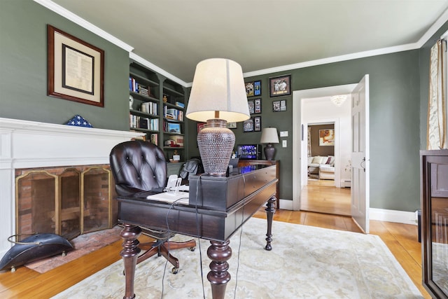 home office featuring built in features, ornamental molding, and wood-type flooring