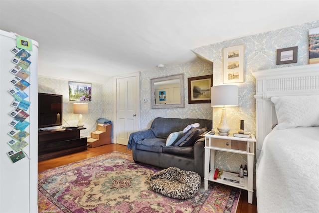 bedroom featuring white refrigerator and wood-type flooring