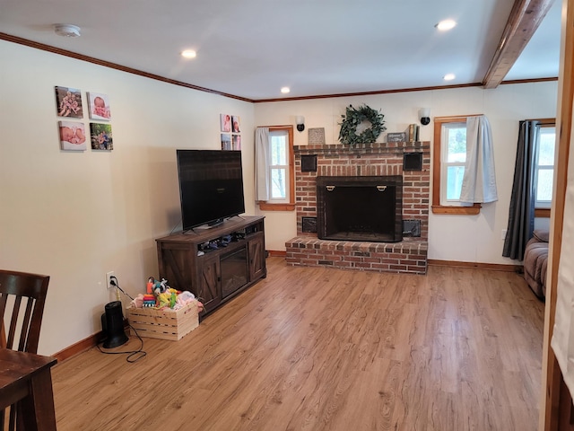 living room with a brick fireplace, light wood-type flooring, and ornamental molding