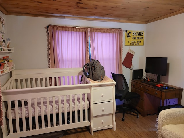 bedroom with light hardwood / wood-style flooring, wood ceiling, and ornamental molding