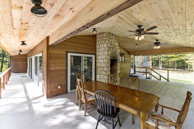 view of patio / terrace featuring ceiling fan and an outdoor fireplace