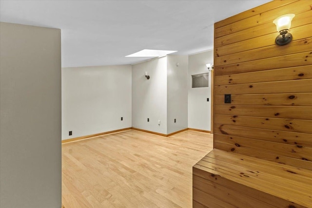 bonus room featuring a skylight and wood-type flooring