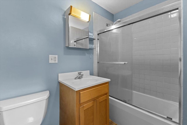 full bathroom featuring bath / shower combo with glass door, vanity, and toilet