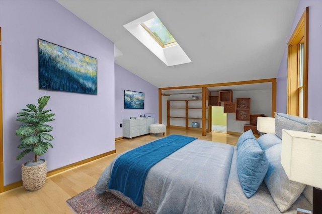 bedroom with light hardwood / wood-style flooring and lofted ceiling with skylight