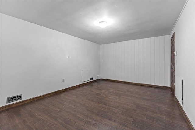 empty room featuring dark hardwood / wood-style flooring