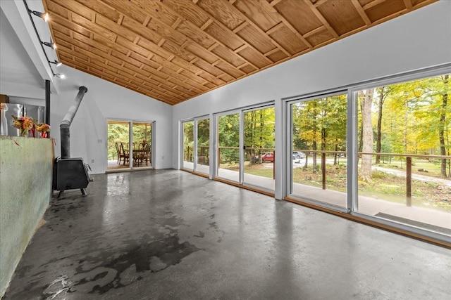 unfurnished sunroom with wood ceiling, a wood stove, and vaulted ceiling