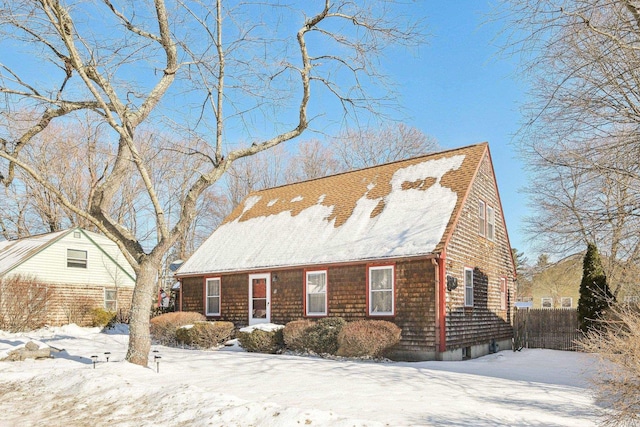 view of snowy exterior featuring fence