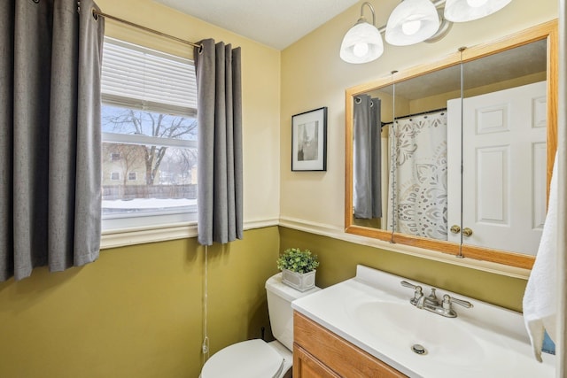 bathroom featuring toilet and vanity