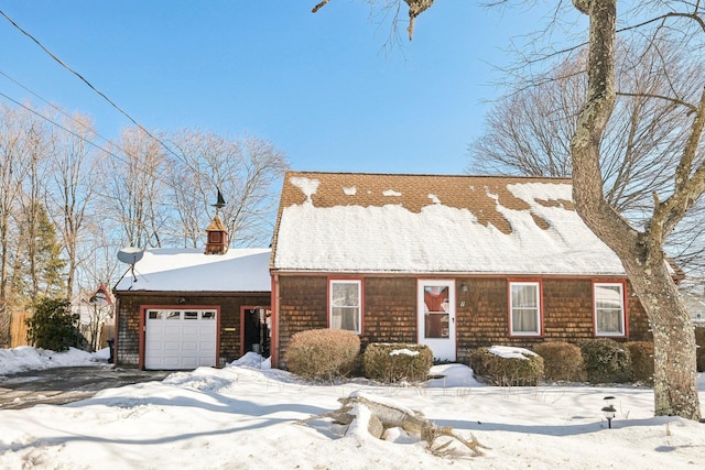 new england style home with a garage and a chimney