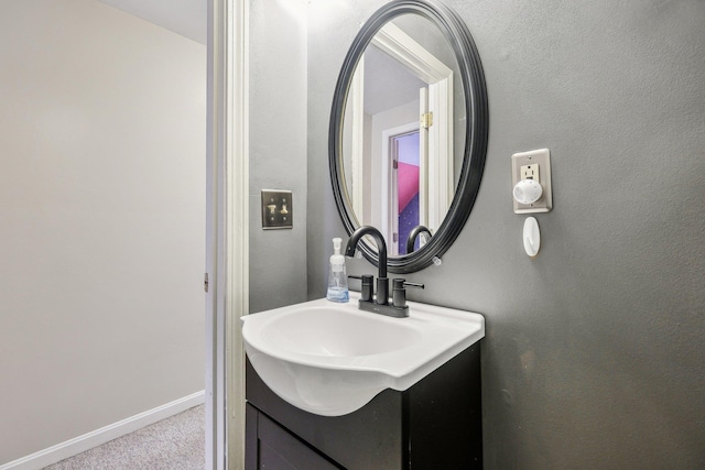 bathroom with baseboards and vanity