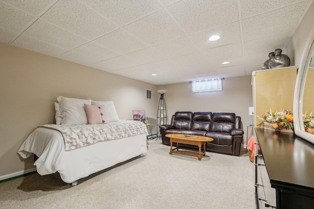 carpeted bedroom featuring visible vents, baseboards, a drop ceiling, and recessed lighting