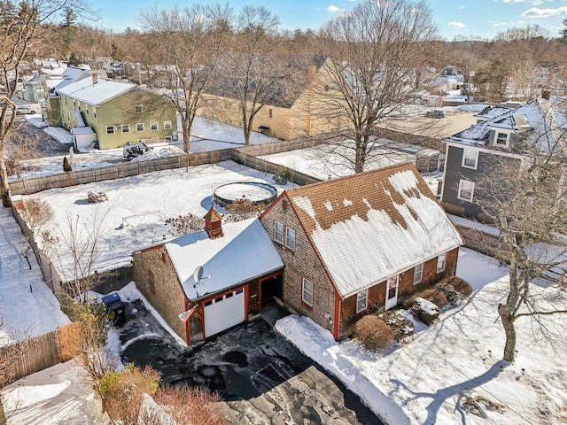 snowy aerial view featuring a residential view