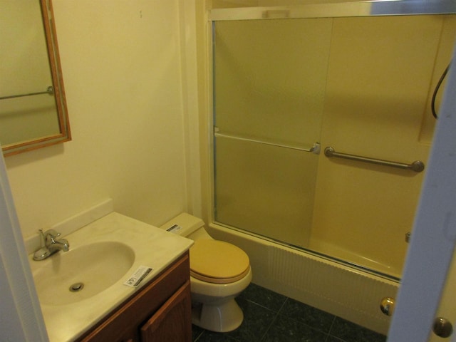 full bathroom with tile patterned floors, toilet, vanity, and shower / bath combination with glass door