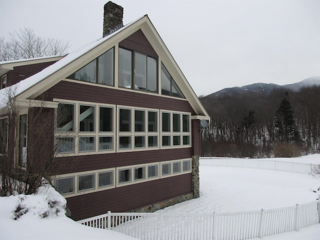 snow covered property with a mountain view