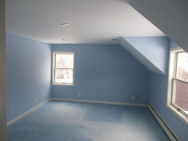 bonus room featuring carpet flooring, vaulted ceiling, and a baseboard heating unit