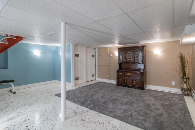 basement with a paneled ceiling