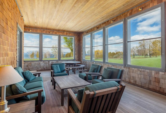 sunroom with a healthy amount of sunlight and wood ceiling