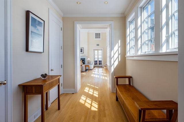 corridor featuring light hardwood / wood-style floors and crown molding