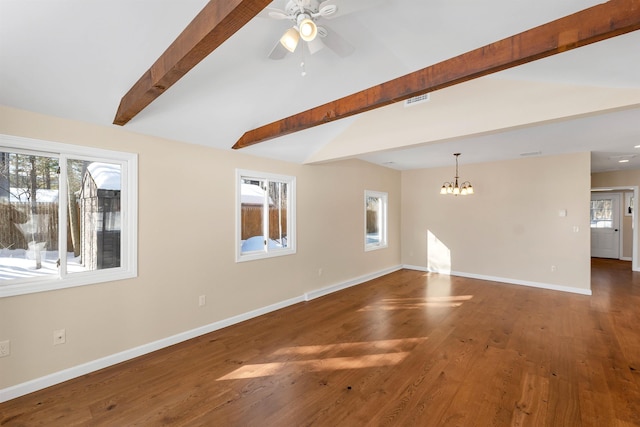 unfurnished living room featuring ceiling fan with notable chandelier, lofted ceiling with beams, dark hardwood / wood-style floors, and a wealth of natural light