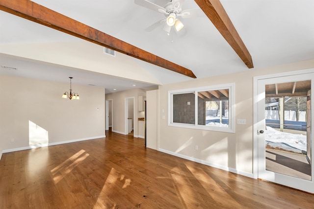 unfurnished living room with ceiling fan with notable chandelier, lofted ceiling with beams, and dark wood-type flooring