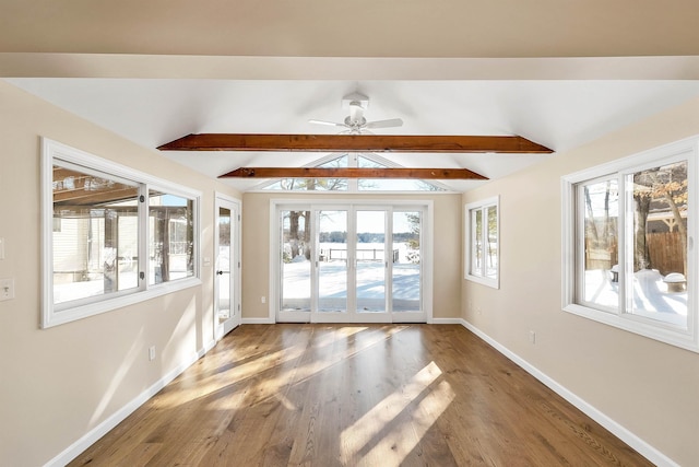 interior space with ceiling fan, hardwood / wood-style flooring, and vaulted ceiling with beams