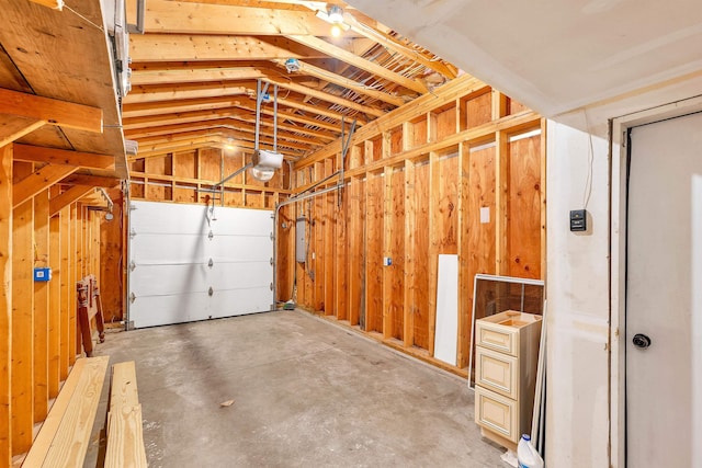 garage with electric panel and a garage door opener