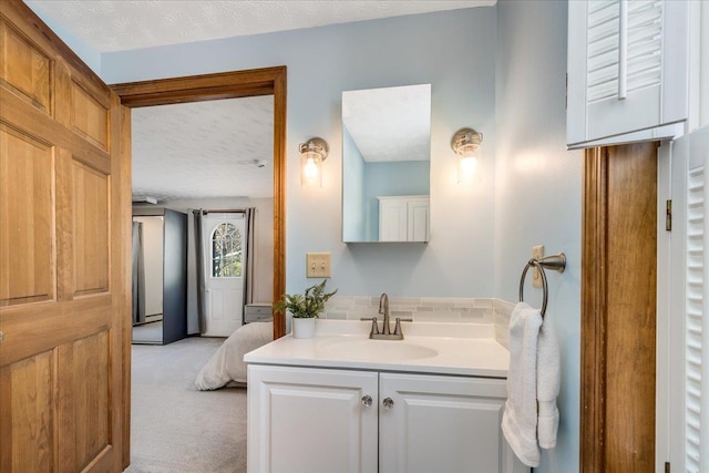 bathroom with a textured ceiling and vanity