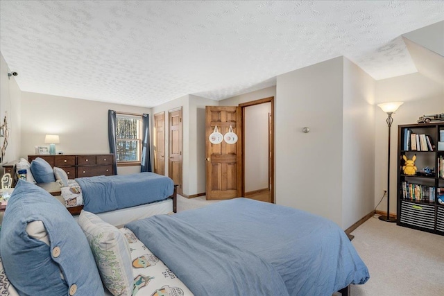 bedroom with a textured ceiling and light carpet