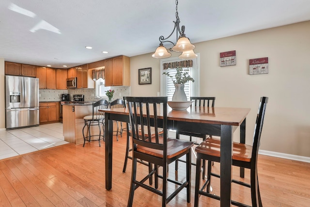 dining space featuring light wood-type flooring