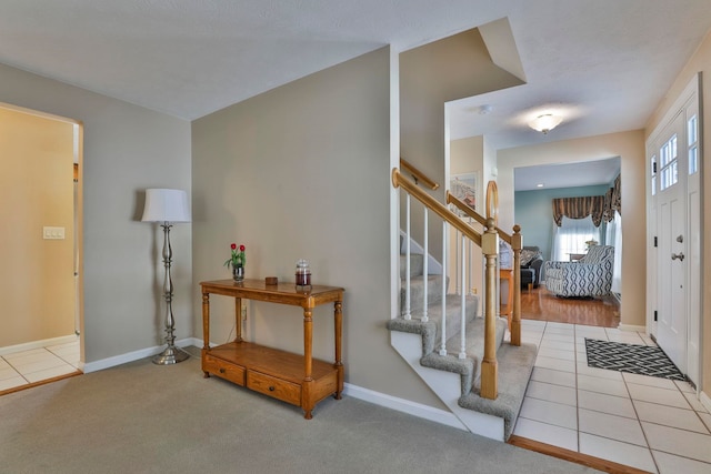 entrance foyer with light carpet