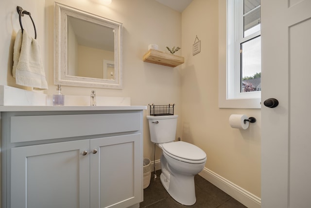 bathroom with vanity, toilet, and tile patterned flooring